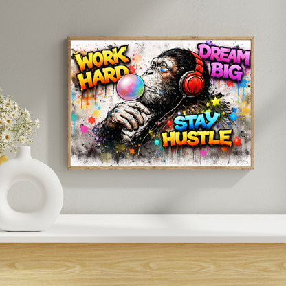 Framed artwork with a monkey wearing headphones and motivational text on a wall.