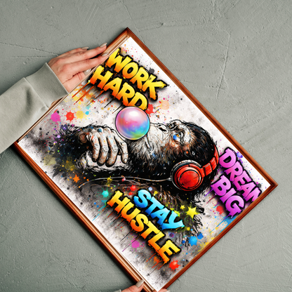 Motivational poster with colorful text and a person wearing headphones, held by a hand on a gray surface.